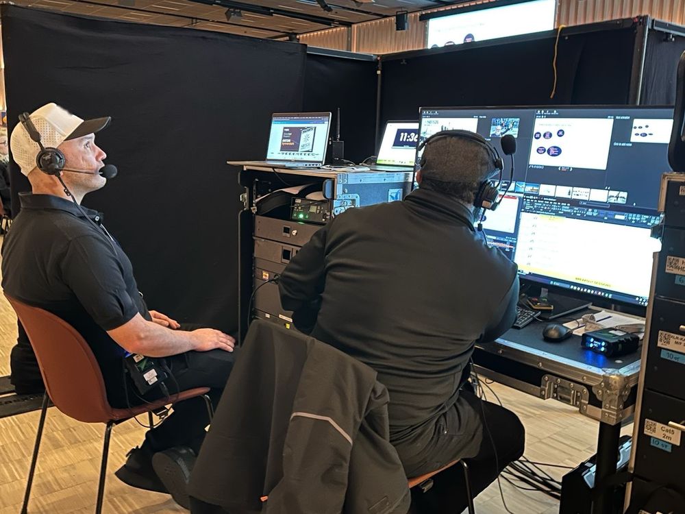 OK with a headset at the control desk, watching the stage